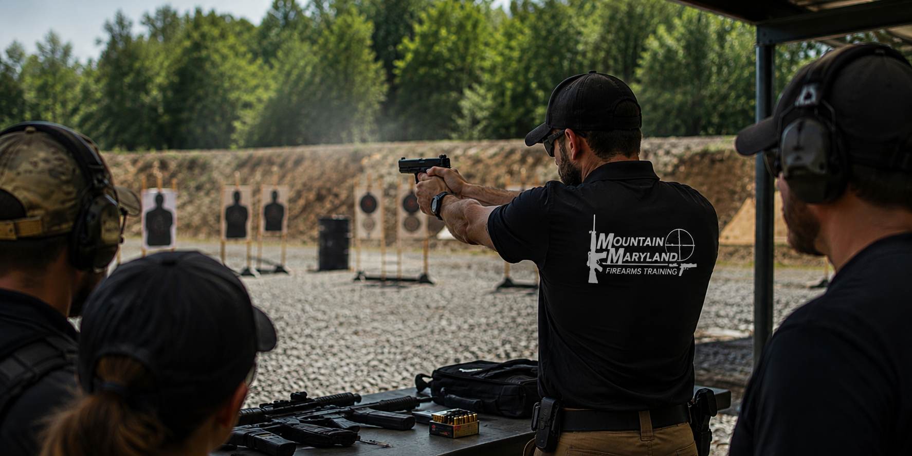 An instructor demonstrating on the firing line while a class watches